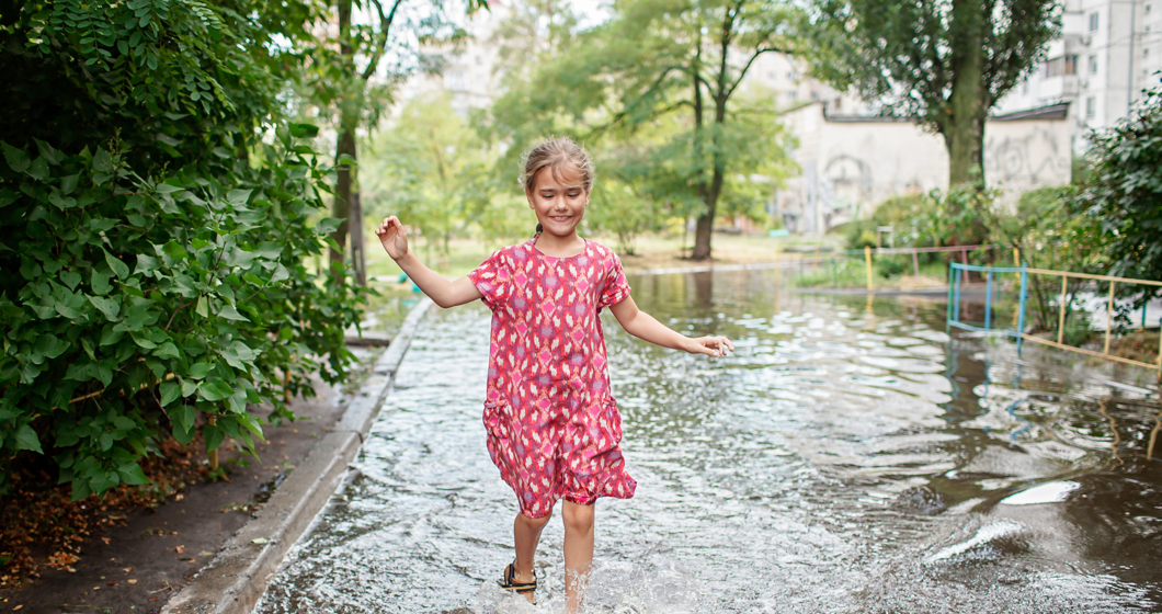Child playing in a puddle.
