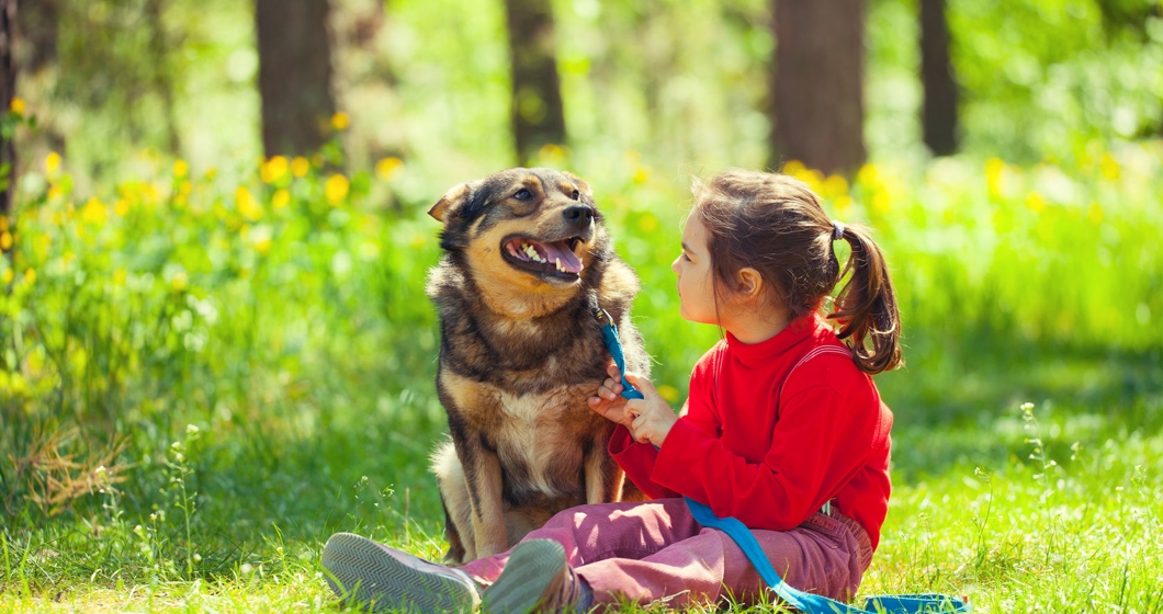 little girl sitting with dog