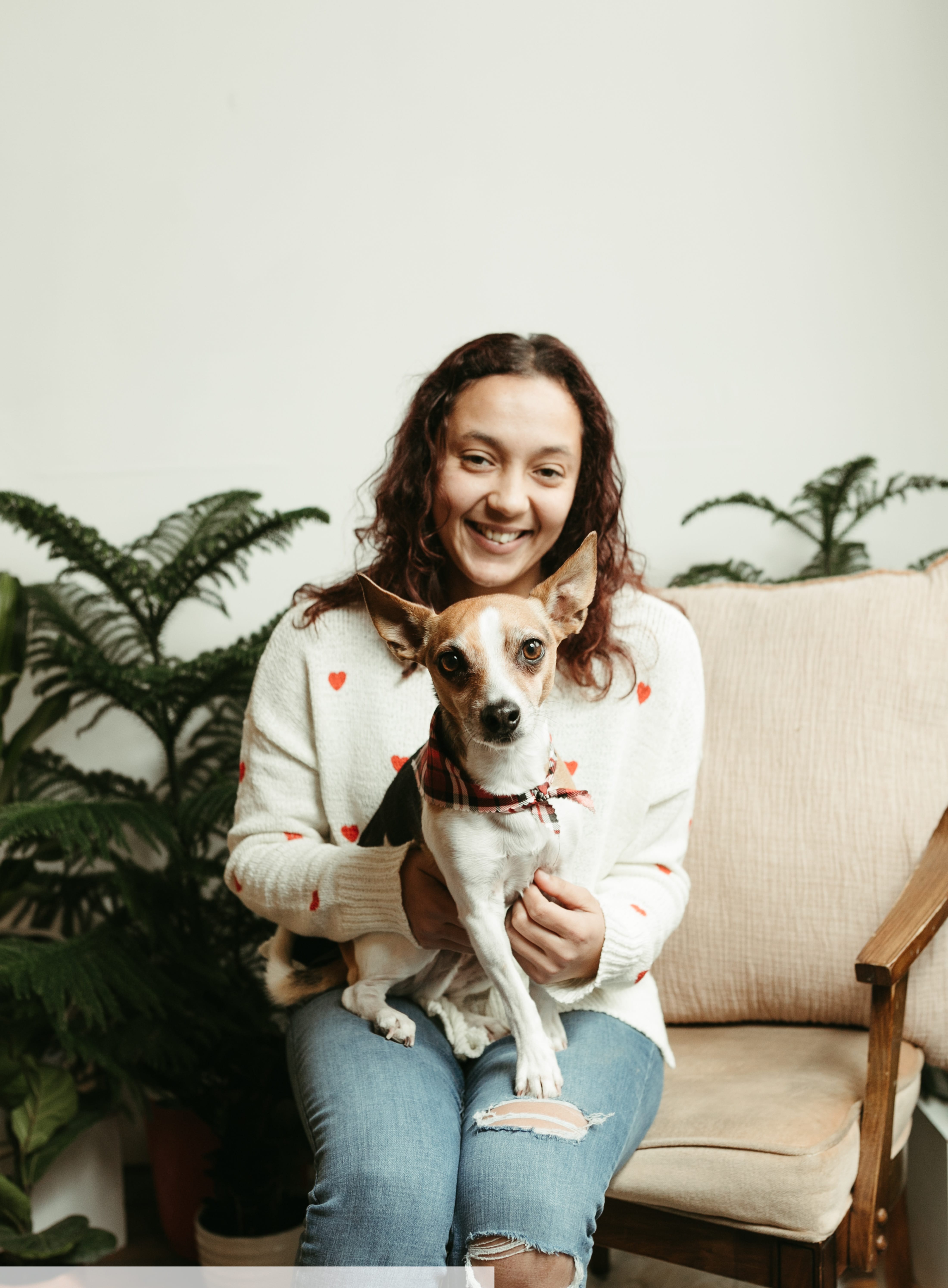 Jasmin Cruz with her dog, Jack, sitting on her lap