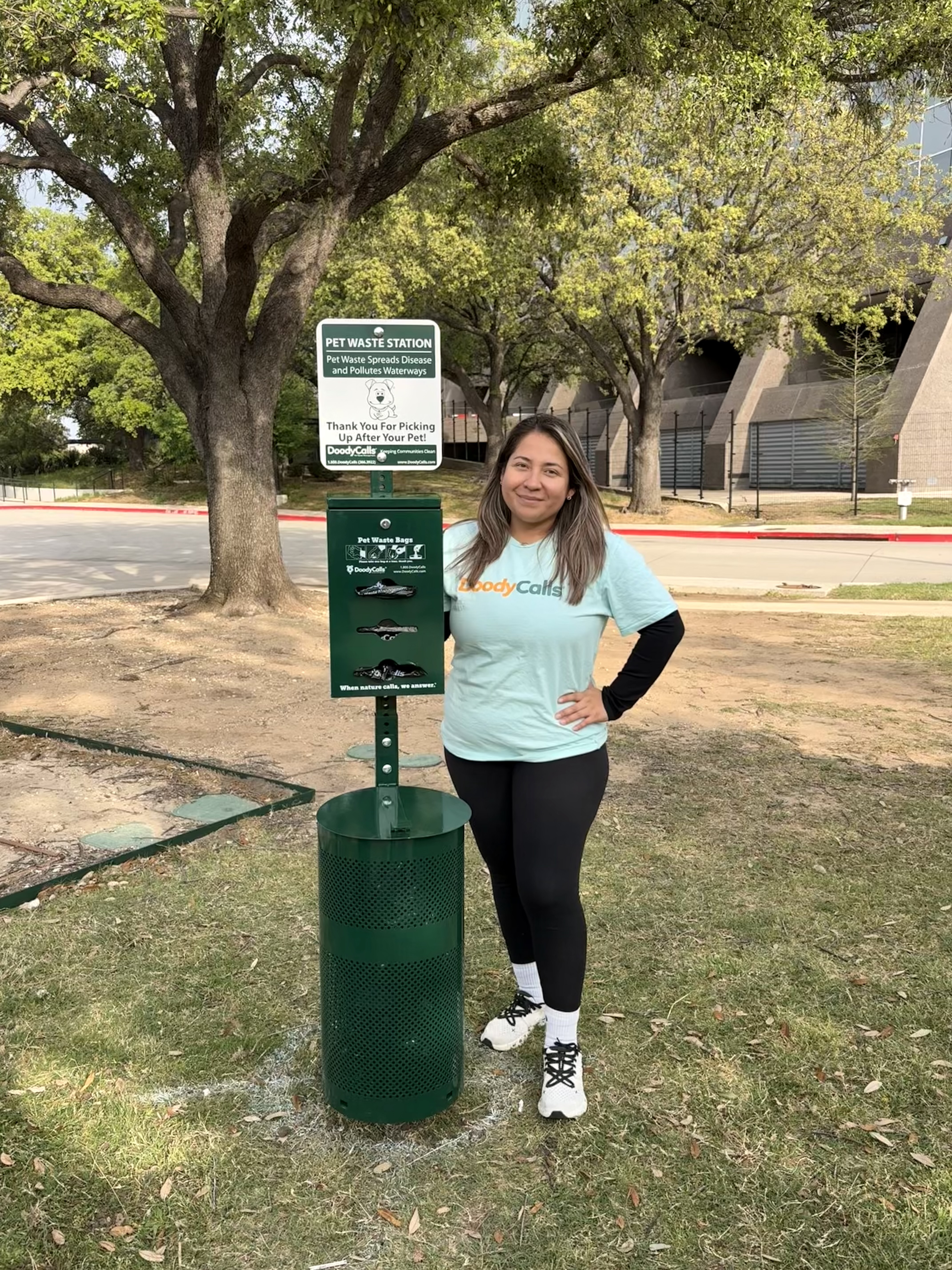 woman by dog clean up station